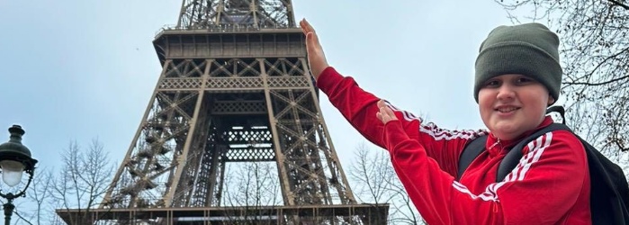 students holding up the eiffel tower